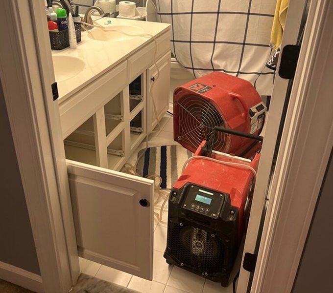 Bathroom Drying Equipment After Toilet Leak Knoxville Air mover and dehumidifier drying a bathroom after a toilet leak in a Knoxville home