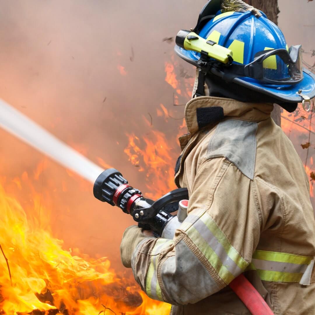 Firefighter House Fire Firefighter spraying water on a house fire