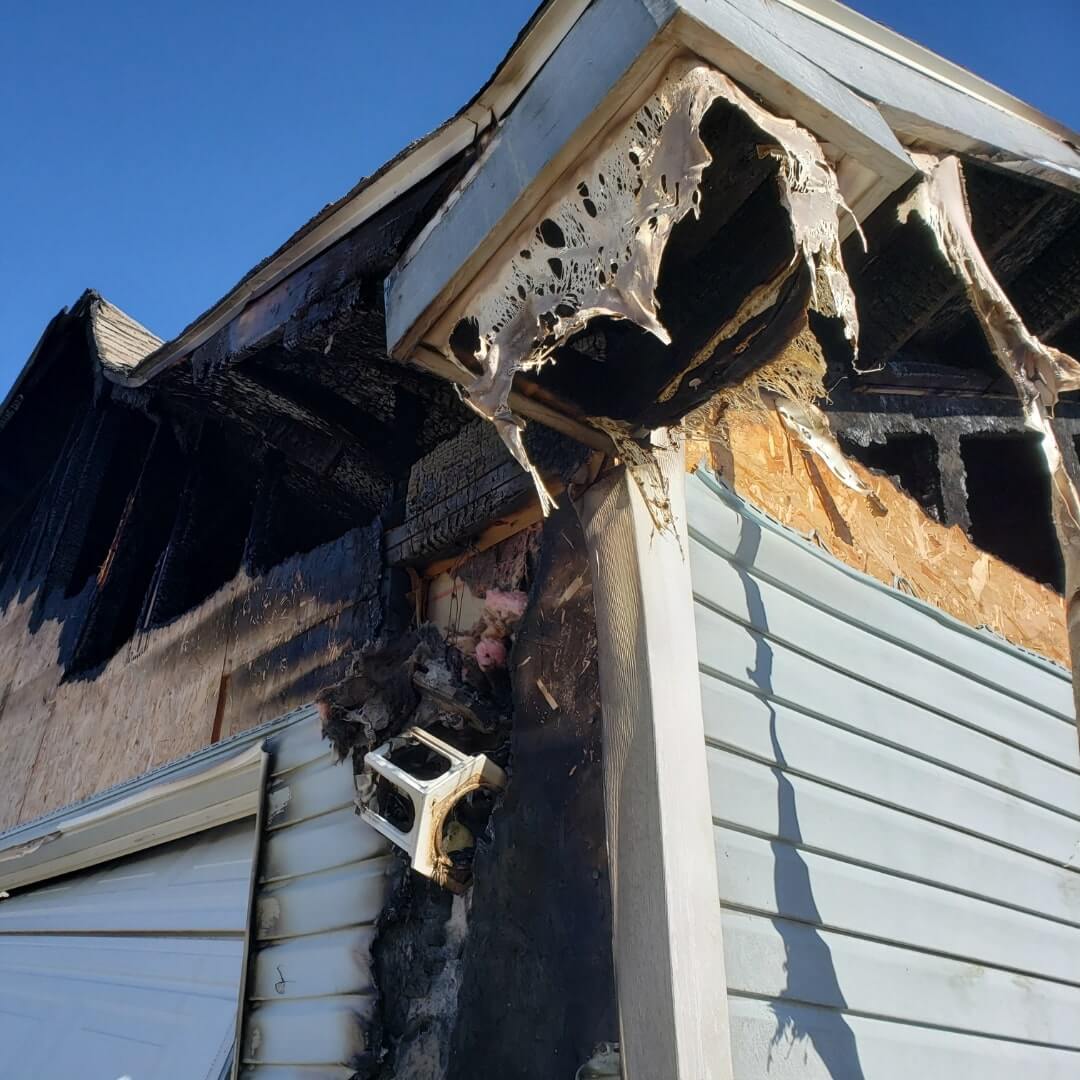 Fire-damaged home exterior that needs professional restoration services