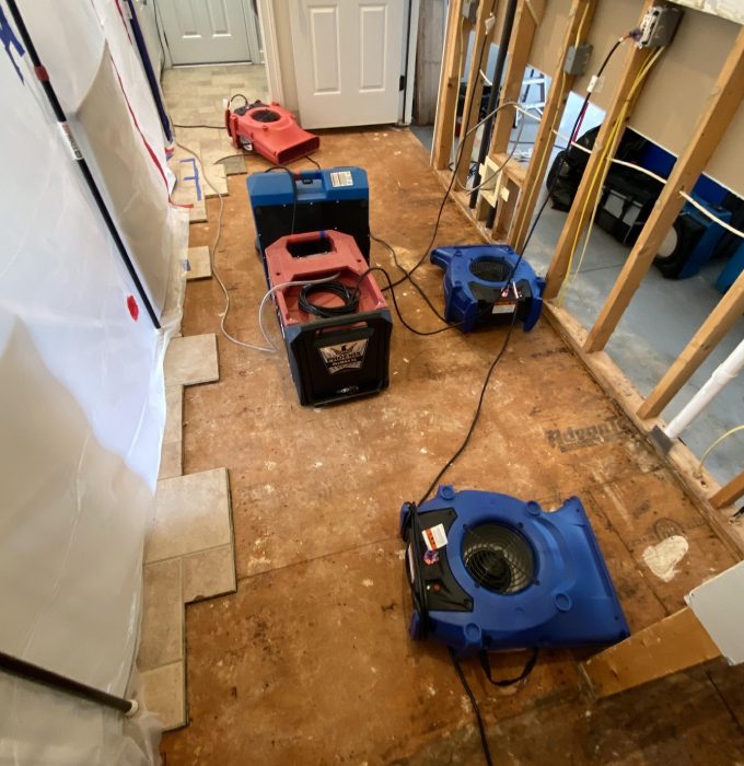 Fire Damage Restoration East Tennessee Air movers and dehumidifiers drying subfloor during water damage restoration in East Tennessee