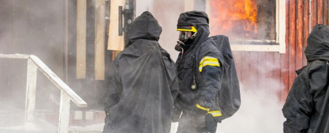 Firefighters Smoke Damage Scene Knoxville TN Firefighters in protective gear at a smoke-filled house fire before smoke damage repair in Knoxville, TN