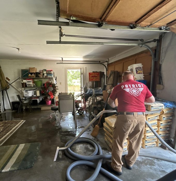 Mold Removal and Remediation Knoxville TN Patriot Restoration technician extracting water from a flooded garage in Knoxville