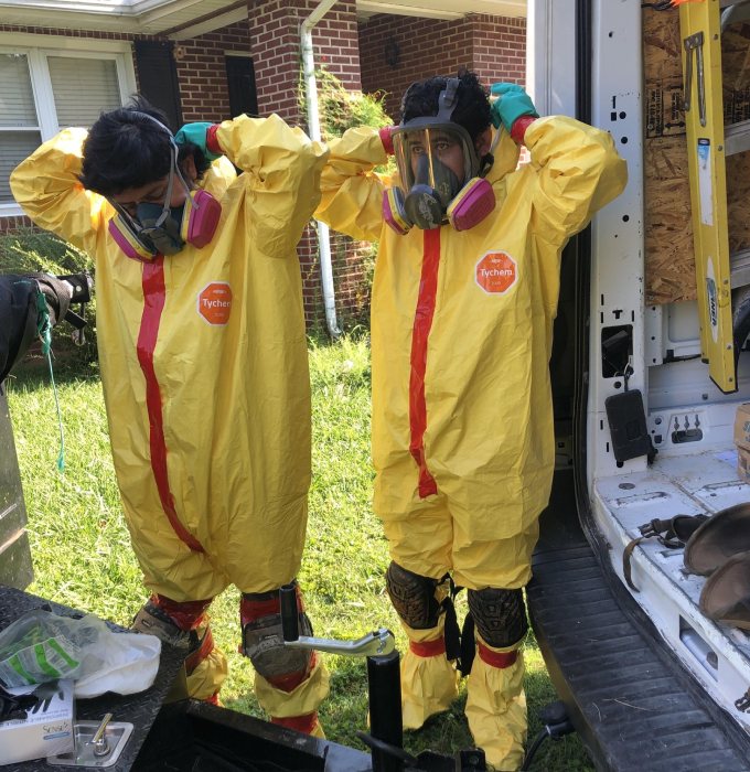Smoke Damage Cleanup Technicians Protective Suits Knoxville Patriot Restoration technicians in protective suits and respirators ready for mold remediation in Knoxville, TN