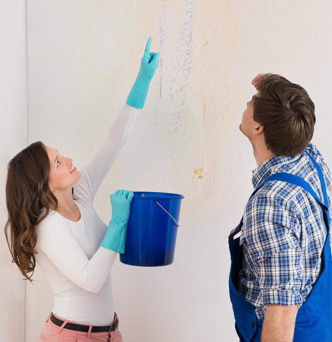 Smoke Damage Repair Knoxville TN Water damage specialist inspecting wall stains for hidden moisture in a Knoxville TN home